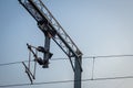 View of overhead electric lines used by train locomotives. Pole supporting the power lines used by electric train engines