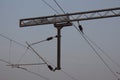 View of overhead electric lines used by train locomotives. Pole supporting the power lines used by electric train engines Royalty Free Stock Photo