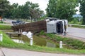 A view of an overturned truck on an highway in an accident.,Thai