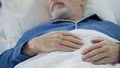 View of overworked wrinkled hands of wise old man peacefully drowsing in bed Royalty Free Stock Photo