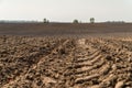 View oÃÂ° a ploughed fields with a tractor tire track.