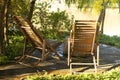 view of a pair of two modern striped brown wooden sun bed loungers near a lake in Brazil Royalty Free Stock Photo