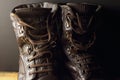 CLOSE VIEW OF A PAIR OF COMBAT BOOTS WITH LOOSE LACES
