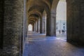 View from Palazzo Pilotta arch in sunlight and shadows across the old town streets of Parma, Italy. The labyrinth of arches Royalty Free Stock Photo