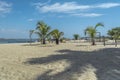 View of palm trees on beach, people and boats, on the island of Mussulo, Luanda, Angola Royalty Free Stock Photo