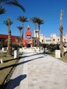 The view of palm trees and beautiful architecture on the territory of the castle in Egypt is the concept of a luxury