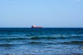 Sea view. Sea and sky panorama. Sea idyll. A lone freighter in the distance. Small sea waves Royalty Free Stock Photo