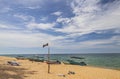 The view of Pantai Jambu Bongkok Beach with flag and boats at Terengganu, Malaysia. Royalty Free Stock Photo