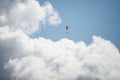 Paraglider flying on blue cloudy sky background Royalty Free Stock Photo