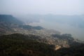 View from a paraglider to the valley and Lake Pheva in Pokhara, Himalayas. Rice fields, mountains and small houses. Tilt Shift Eff