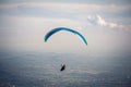 Paraglider flying in the blue sky. Italian Alps. Piedmont. Italy Royalty Free Stock Photo