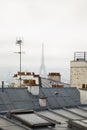 View of Paris on a cloudy foggy day from the Montmartre hill through the roofs of houses Royalty Free Stock Photo