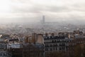 View of Paris on a cloudy foggy day from the Montmartre hill through the roofs of houses Royalty Free Stock Photo