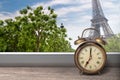View of Paris and Eiffel tower from window with alarm clock Royalty Free Stock Photo