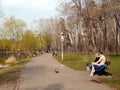View of the park Peremoga and relaxing people on a spring day. Kiev, Ukraine