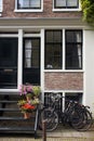 View of parked bicycles and flowers on stairs in front of typical and traditional building