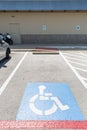 View of the parking sign for people with disabilities. Parking for disabled people and wheelchair symbols on the asphalt Royalty Free Stock Photo