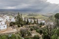 View of a part of the city of Ronda with its white houses in the top of the canyon illuminated by the sun`s rays Royalty Free Stock Photo