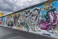 View of part of the old existing Berlin Wall, covered with graffiti made by people from all over the world. Royalty Free Stock Photo