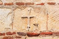 View of a part of the wall of an ancient Byzantine Christian temple with a cross closeup Royalty Free Stock Photo