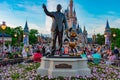 View of Partners Walt Disney and Mickey Mouse statues and colorful flowers at Magic Kingdom in Walt Disney World.