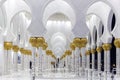 View of the passage through the arches of The Sheikh Zayed Grand Mosque with marble columns ornate with gold and mosaics pictures