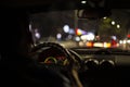 View from the passenger compartment of the night road illuminated by the fog lights of the car, with poor visibility on the wet Royalty Free Stock Photo