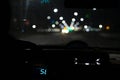 View from the passenger compartment of the night road illuminated by the fog lights of the car, with poor visibility on the wet Royalty Free Stock Photo