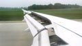 View from passenger window of aircraft during landing on runway