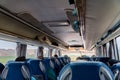 View of the passengers inside a stage coach bus. Bus interior trip. Transport, tourism, road trip and people concept Royalty Free Stock Photo