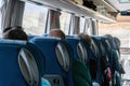 View of the passengers inside a stage coach bus. Bus interior trip. Transport, tourism, road trip and people concept Royalty Free Stock Photo