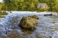 A view past boulders beside the banks of the River Teifi at Cenarth, Wales Royalty Free Stock Photo