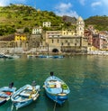 A view past fishing boats towards the picturesque village of Vernazza