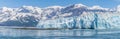 A view past an islet towards the Hubbard Glacier with mountain backdrop in Alaska Royalty Free Stock Photo