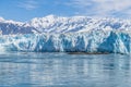 A view past an islet towards the snout of the Hubbard Glacier with mountain backdrop in Alaska Royalty Free Stock Photo