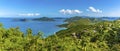 A view past lush vegetation towards the islands of Guana, Great Camanoe and Scrub from the main island of Tortola Royalty Free Stock Photo