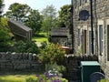 View past, old stone cottages, and gardens on, Coplowe Lane, Wilsden, UK Royalty Free Stock Photo