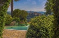 A view past a pool towards the Umbrian village of Collazzone near Todi, Italy