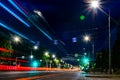 View of the central street of the night city with the bright light of the street lights of evening lighting with informative road
