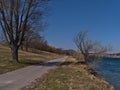 View of paved footpath on Donauinsel (Danube Island) in the north of city Vienna, Austria on sunny day in spring.