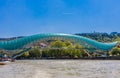 The view on the Peace Bridge with the Sololaki Hill and old town buildings on the background, Tbilisi, Georgia Royalty Free Stock Photo