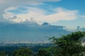 View of the peak of Mount Semeru behind the clouds