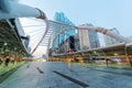 View of a pedestrian overpass in downtown of Bangkok City with high rise buildings in the background in early morning light