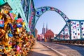 View of the pedestrian Tumski Bridge is also called Lovers Bridge, Cathedral Bridge or Green Bridge, adorned with many love lock Royalty Free Stock Photo