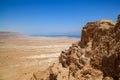 View of a pedestrian walkway up the side of Masada mountain, with Dead Sea in hazy background