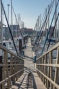 View of a pedestrian wood structure and recreational and private boats in Marina