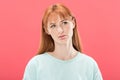 View of pensive redhead young woman looking away isolated on pink