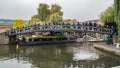 View of people crossing a bridge over the canal at Camden town at the entrance of the Lock market in London