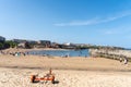 View of people enjoying the sunny weather at the coast, Cullercoats Bay, North Tyneside. UK