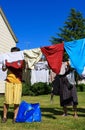 View of people hanging laundry on clothesline in backyard Royalty Free Stock Photo